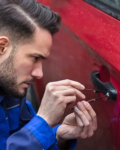 Locksmith Dunnegan specialist replacing a car key with precision tools.